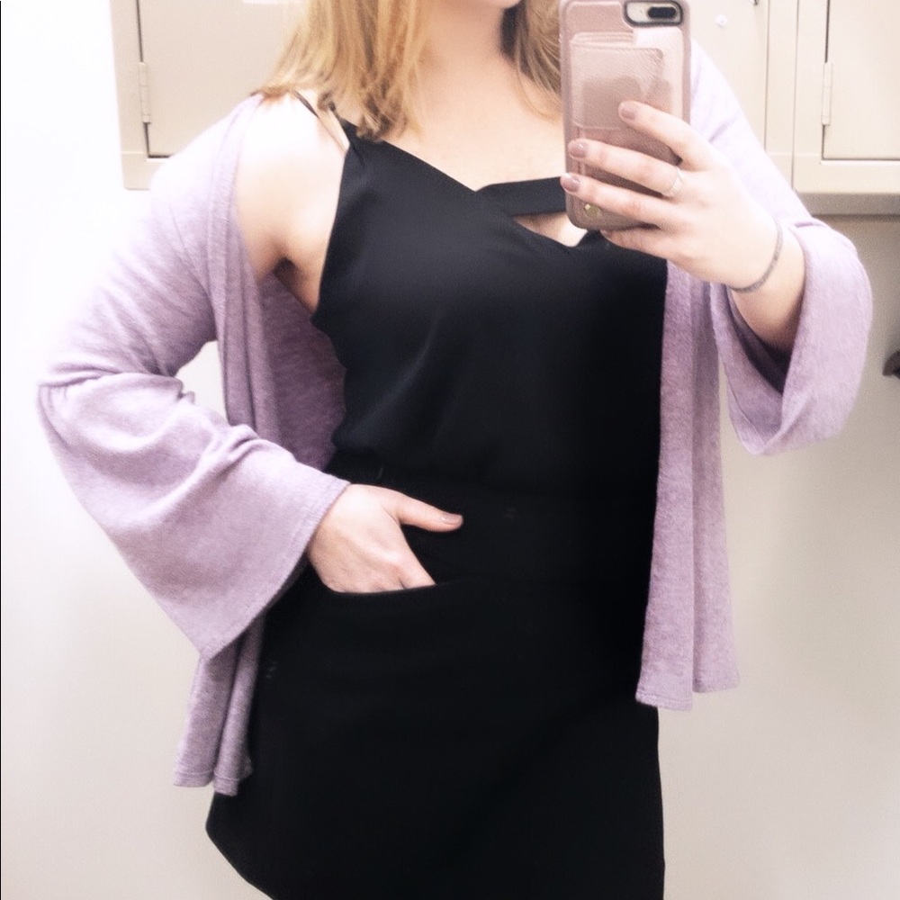 Purple sweater with bell sleeves.